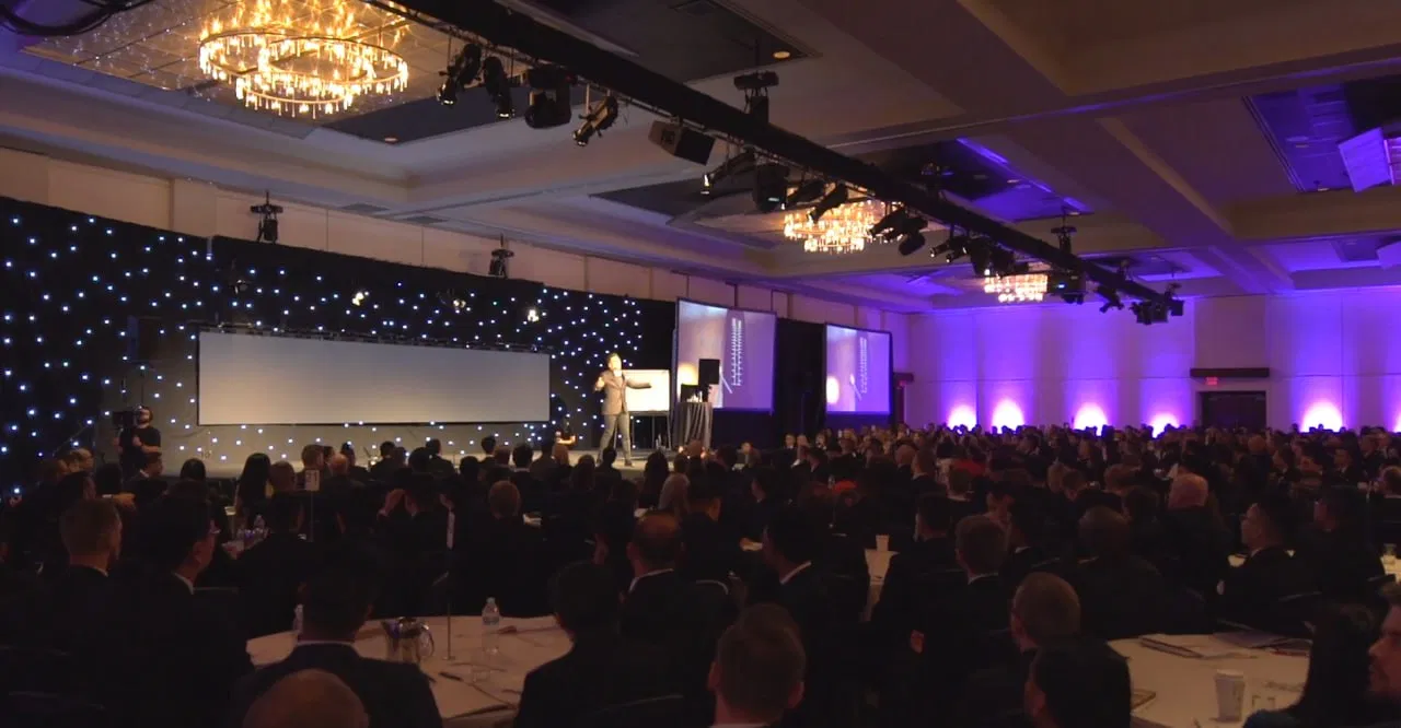 Kayvon Kay delivering a keynote to a packed corporate ballroom